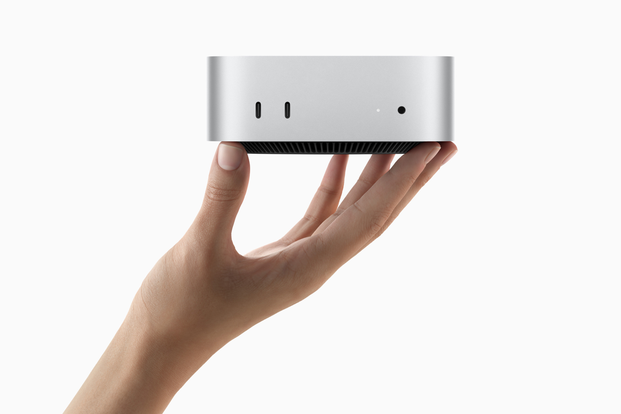 Mac Mini tenu dans une main